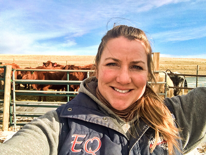 An image of Kirstie Wachholtz with cows in the background