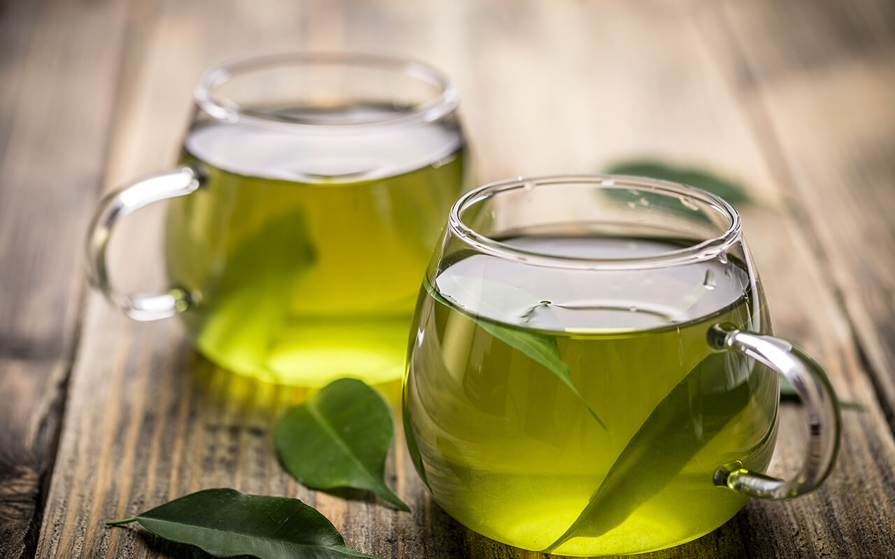 two cups in the table with green tea